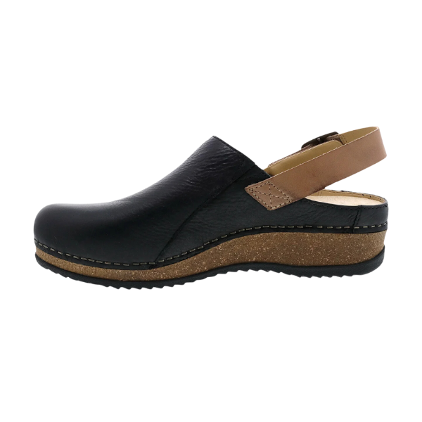 The DANSKO Womens Merrin Black is a black leather clog with a brown adjustable slingback strap and sustainable cork midsole, shown in side profile against a white background.
