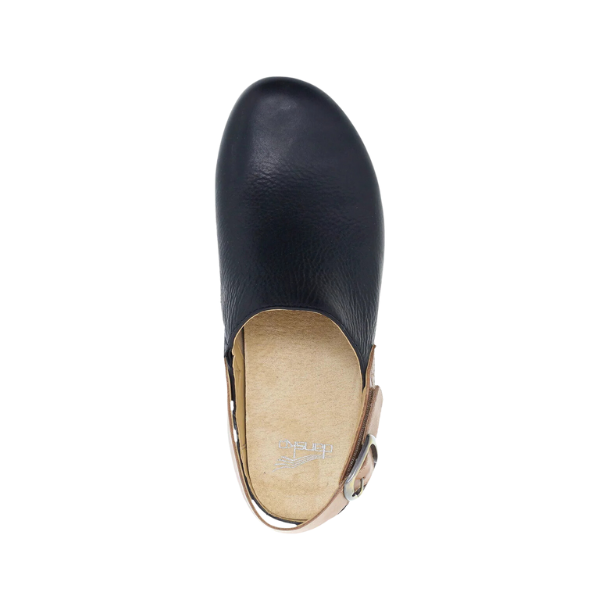 Top view of the Dansko Womens Merrin Black clog by DANSKO, featuring black leather, a beige sole, tan adjustable ankle strap with buckle, and a sustainable cork midsole for comfort and support.