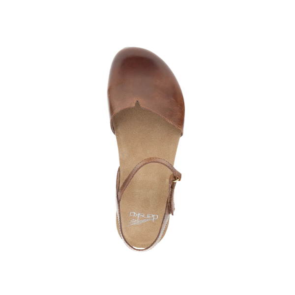 Top view of the Dansko Womens Rowan Tan by DANSKO—a brown leather flat sandal with closed toe, ankle strap, and memory foam insole for foot pain relief—displayed on a white background.