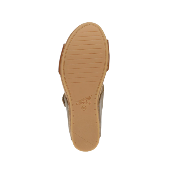 The image displays the bottom of a single Dansko Womens Shannon Gold/Tan wedge slide sandal by DANSKO, featuring a lightly textured rubber sole for foot pain relief, the DANSKO logo in the center, and size number 38.