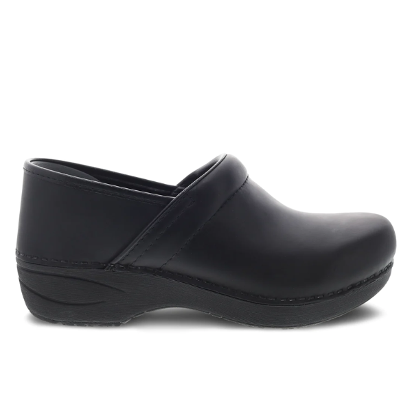The Dansko Womens XP 2.0 Black Pull Up by DANSKO is a black leather clog with closed toe, raised heel, visible stitching, and slip-resistant outsole, displayed in side profile on a white background.