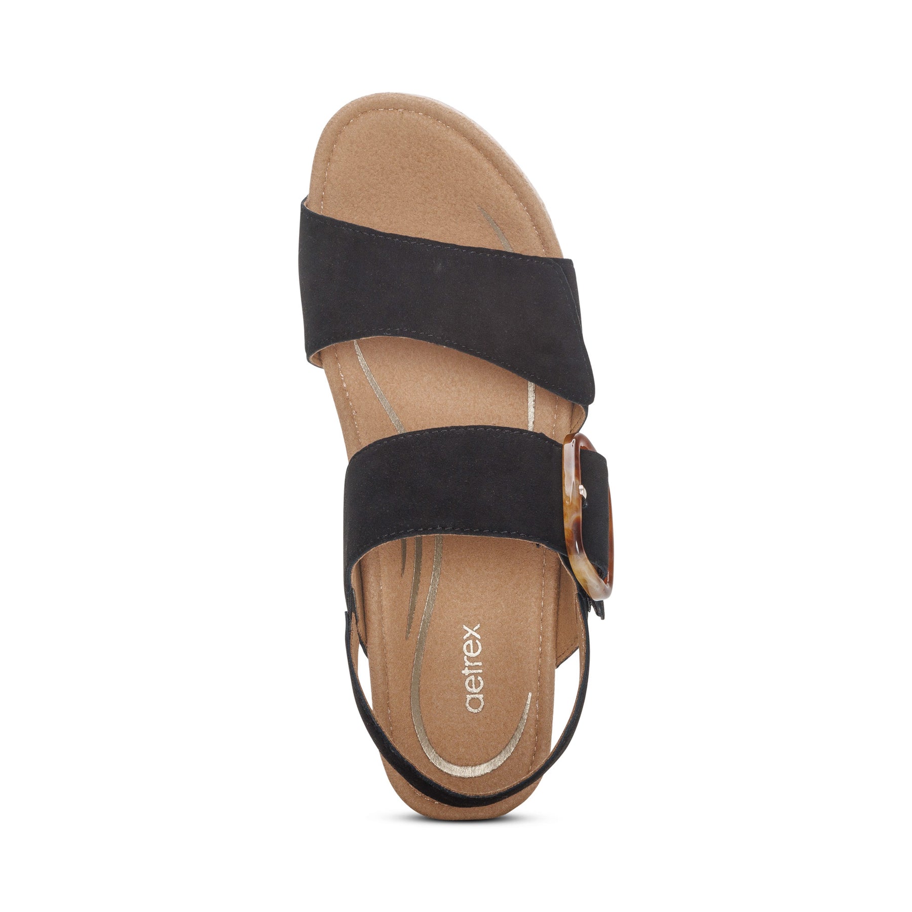 The Aetrex Womens Ashley Espadrille Wedge Black by AETREX WORLDWide INC features a Wide black suede strap, large buckle detail, and a cushioned tan memory foam footbed for comfort. The insole displays the brand name.