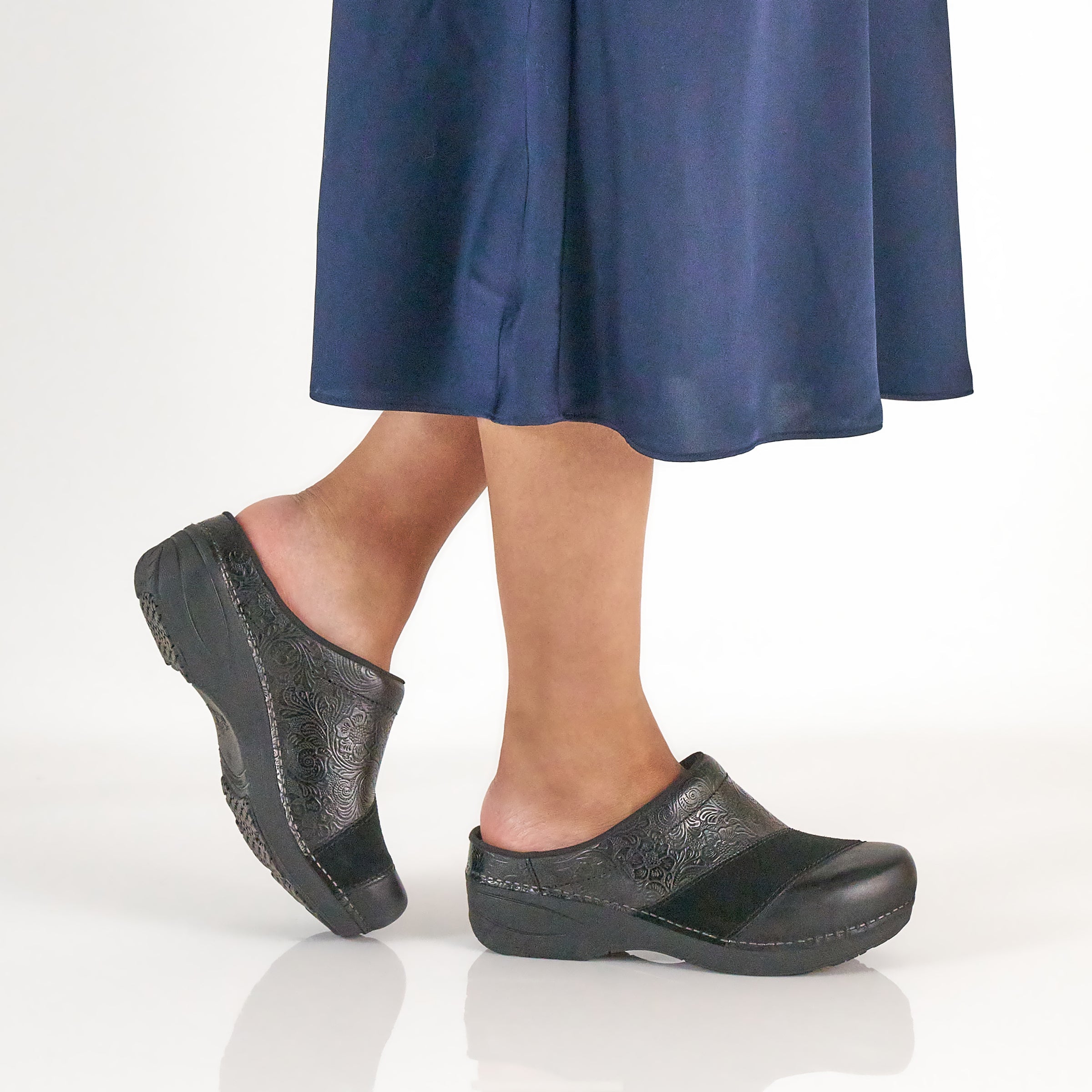 DANSKO Women's Zinnia Clog Black worn in a lifestyle setting, open-back clog with arch support.