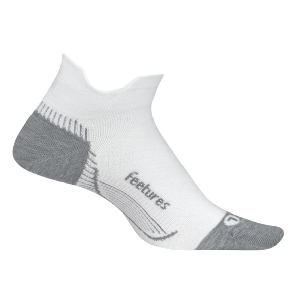 The FEETURES Plantar Fasciitis Relief Sock Ultra Light No Show Tab in White is a low-cut athletic sock with light gray heel and toe. It offers targeted compression for comfort and features feetures in gray on the arch.