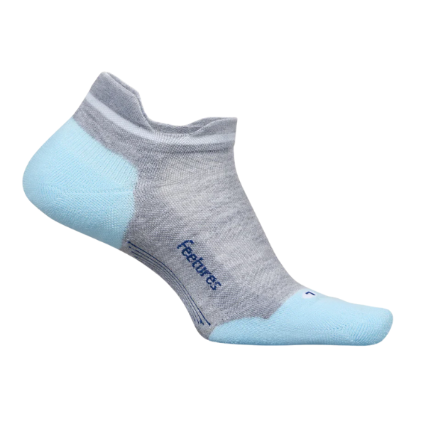 The FEETURES Elite Max Cushion Tab sock in Grey/Blue is a single low-cut sock with light blue heel and toe, targeted compression for a secure fit, and “Feetures” printed in blue on the side.