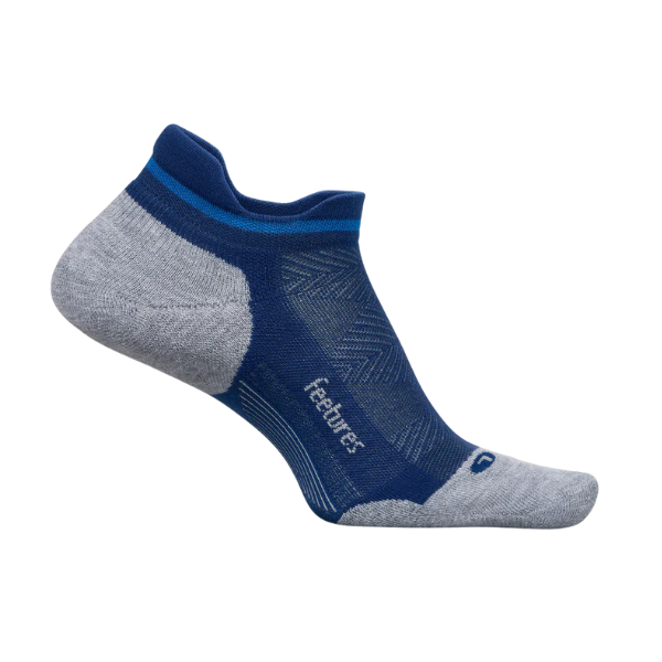 The FEETURES Elite Max Cushion Tab Navy/Grey is an athletic ankle sock with mesh ventilation and reinforced heel and toe, shown on an invisible foot form. The FEETURES logo appears on the side for a custom-like fit.