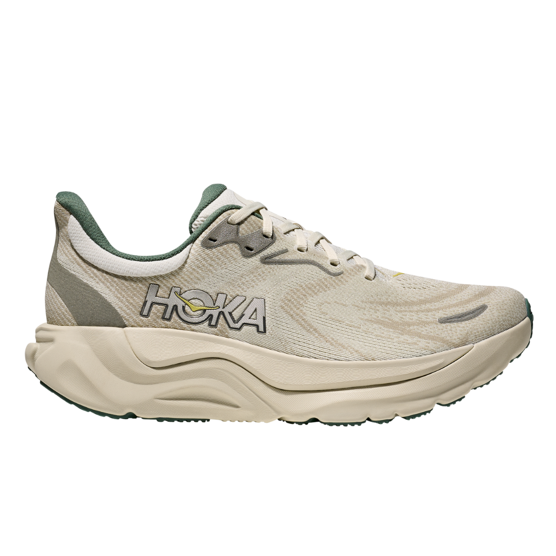 The HOKA Mens Arahi 8 Truffle/Oyster stability shoe features a thick, wavy sole with H-frame™ technology, mesh upper, and side logo, displayed in profile against a white background.