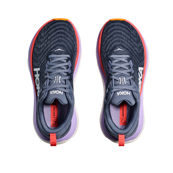 A pair of HOKA Womens Gaviota 5 Wide running shoes in Anchor/Grapefruit, featuring blue uppers, white logos, coral red pull tabs, lavender midsoles, orange heel accents, and stabilizing H-Frame tech, viewed from above on white.