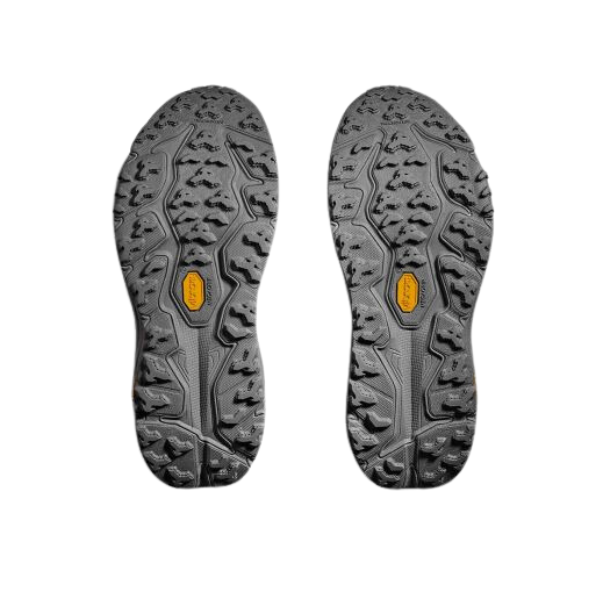 A pair of HOKA Womens Speedgoat 6 Stellar Grey/Asteroid Wide shoes with rugged Vibram Megagrip soles and textured tread for trail running traction, shown side by side on a white background.