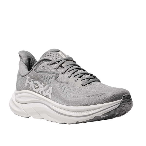 The HOKA Mens Clifton 10 Wide Grey features a thick white sole, mesh upper, and bold side logo. Angled to showcase its cushioned design, this running shoe offers comfort and support for foot pain relief.