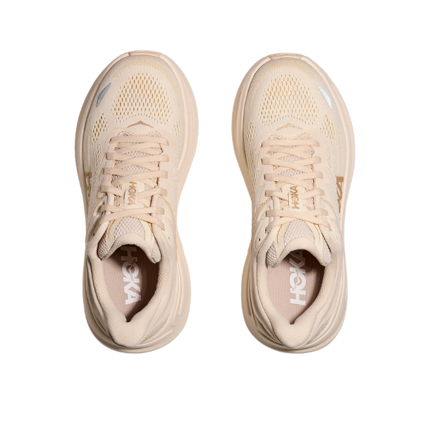 A pair of HOKA Womens Bondi 9 Wide running shoes in Vanilla/Birch, shown from above on a white background, features mesh uppers, laces, and HOKA branding on the tongue and insole—designed for comfort and foot pain relief.