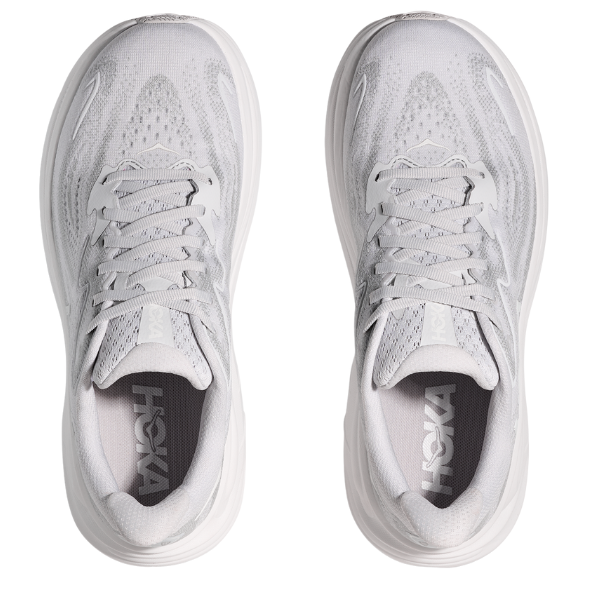 Pair of white running shoes with 'Hoka' branding on a white background