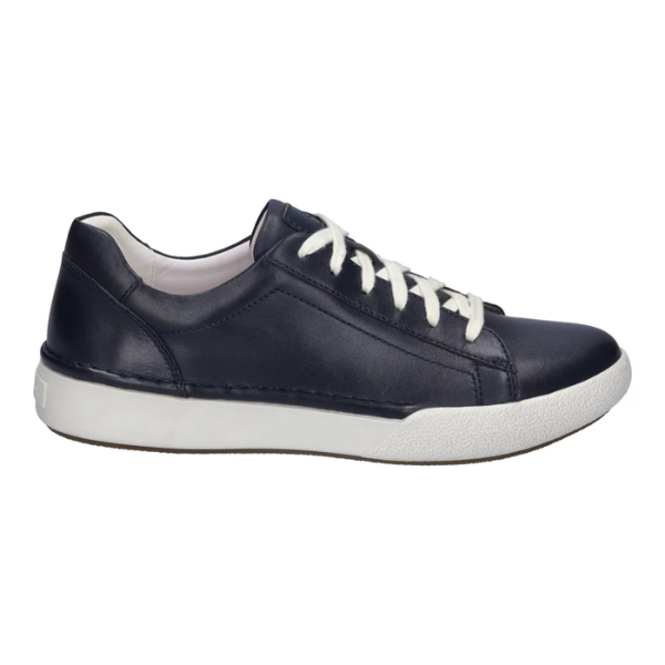 The Josef Seibel Womens Claire 01 Indigo is a navy blue leather sneaker with white laces and a white rubber sole, designed for comfort and foot pain relief, shown from the side on a plain white background.