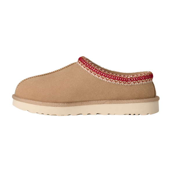 The UGG Women's Tasman II Sand is a tan suede slide with a cream sole and decorative red and cream woven trim around the ankle, blending signature UGG style and comfort.