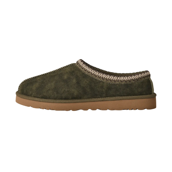 A side view of the UGG Men's Tasman Baxter Burnt Olive slipper by UGG, showcasing a green suede upper, UGGplush lining, tan rubber sole, and decorative ankle stitching.