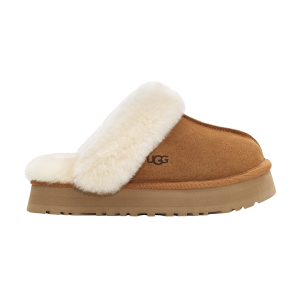 The UGG Women's Disquette Chestnut is a tan sheepskin slip-on with a thick light brown sole, plush cream fur lining and trim, and the UGG logo on the side—offering cozy comfort as the perfect women's platform slipper.