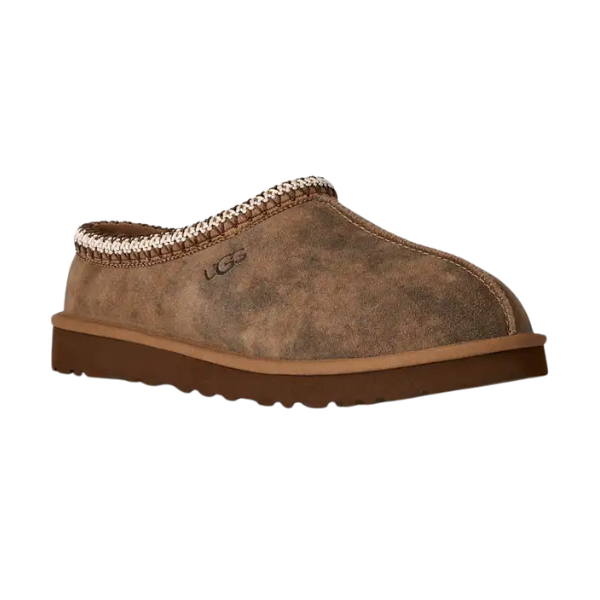 The UGG Men's Tasman Baxter Chestnut is a brown suede slip-on clog with a thick rubber sole, decorative top-edge stitching, cozy UGGplush lining, and an embossed UGG logo—drawing inspiration from the iconic Tasman style.