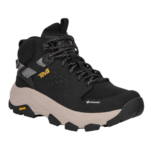 The TEVA Women's Grandview Max GORE-TEX Black hiking boots feature a waterproof design with a thick beige sole, gray laces, yellow branding, and are built for outdoor adventures and rugged terrain.
