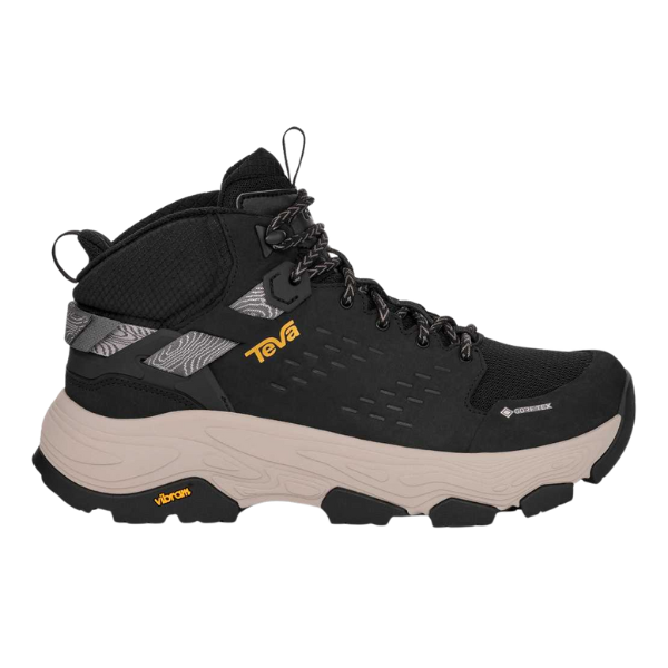 The TEVA Women's Grandview Max GORE-TEX Black hiking boot features a thick beige sole, black and gray upper, black laces, yellow logo, rugged tread, and is waterproof—perfect for outdoor adventures.