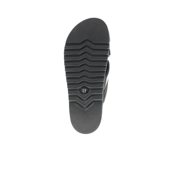 The Sovella Womens Coty Black Sandal by SOVELLA is shown from the bottom, highlighting its textured sole with horizontal grooves and a central size 39 label. This cushioned, versatile sandal is set against a white background.