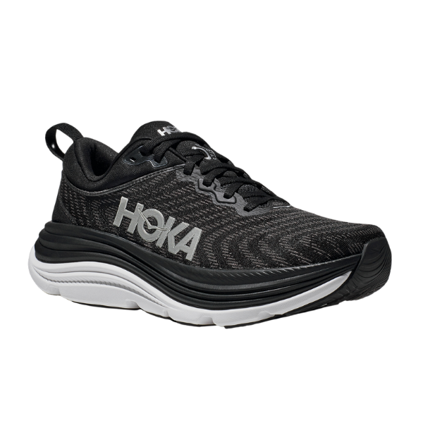 The HOKA Womens Gaviota 5 (Medium) in Black/White features a thick cushioned sole, stabilizing H-Frame for foot pain relief, white accents, black laces, and the HOKA logo on the side. The shoe is shown angled to display its side and front.