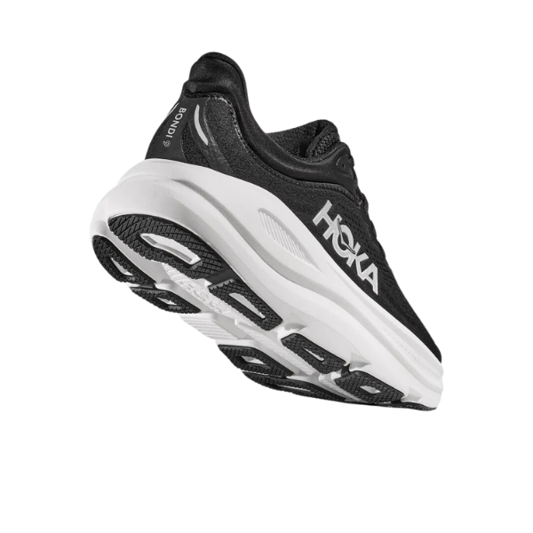 The HOKA Mens Bondi 9 in black and white is shown from a low rear angle, featuring plush cushioning for foot comfort and the HOKA logo on the side, set against a white background.