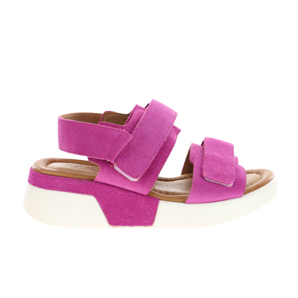 The SOVELLA Womens Maya Pink sandal features thick pink suede straps, white Velcro fastenings, a chunky white sole, and a cushioned insole for all-day comfort—perfect for adding a pop of color to your look.