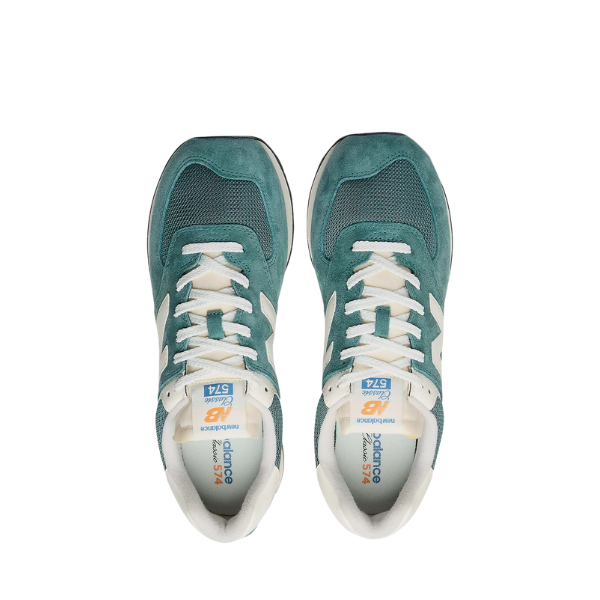 A pair of NEW BALANCE Unisex's 574 Spruce/Sea Salt sneakers with white laces and accents, shown from above on a white background—classic shoes combining style with foot pain relief.