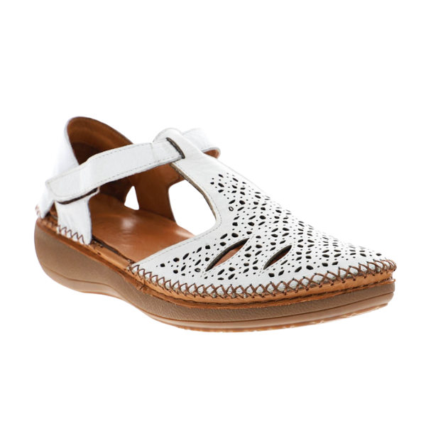 The SOVELLA Womens Sabrina White Sandal features decorative cut-outs, a closed toe, cushioned brown sole, and an adjustable ankle strap for comfort and style.