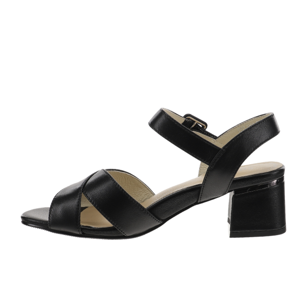 The Sovella Womens Celine Sandal in black by SOVELLA features premium leather, an open toe, low block heel, crisscross front straps, and an ankle strap with a small buckle, shown on a white background.