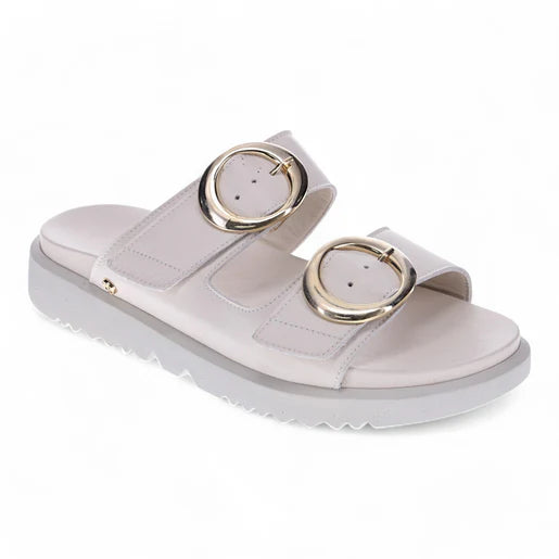 The REVERE Revere Womens Mermaid Ivory is a premium white leather slide sandal with two Wide adjustable straps, large round gold buckles, and a thick textured sole for grip—combining comfort and style.