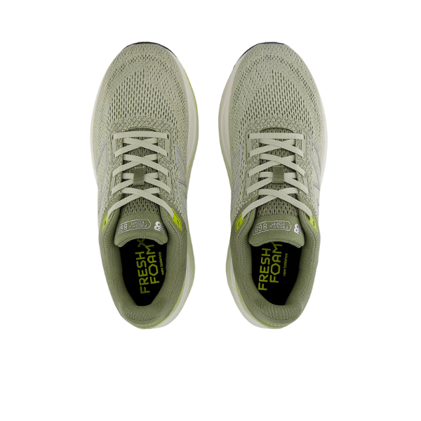 Top view of NEW BALANCE Mens Fresh Foam 860v14 Green with white laces, mesh upper, lime green accents, and Fresh Foam-branded insoles for a cushioned running experience.