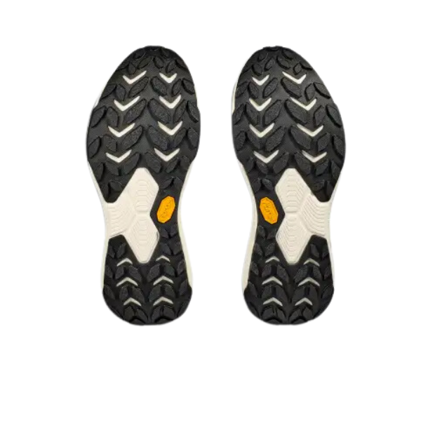 The HOKA Mens Transport Wide Black/White shoes feature rugged, chevron-patterned hiking soles with yellow VIBRAM logo patches, displayed side by side on a white background.