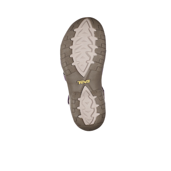 The image shows the sole of the Teva Womens Tirra in Grey Ridge/Purple, featuring a textured, non-slip tread in light and dark brown with a yellow Teva logo near the center—a top pick among womens sport sandals.