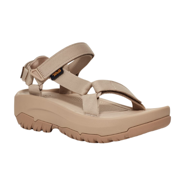 The Teva Womens Hurricane XLT2 Ampsole Sesame is a beige sport sandal with thick adjustable straps and a rugged, textured sole, designed for outdoor comfort and made with recycled materials.