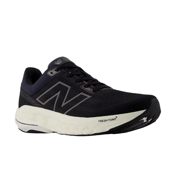 The New Balance Womens Fresh Foam 860v14 Black/White running shoe features mesh fabric, a large N logo, Fresh Foam text on the white sole, and a Stability Plane for enhanced support and smoother strides.