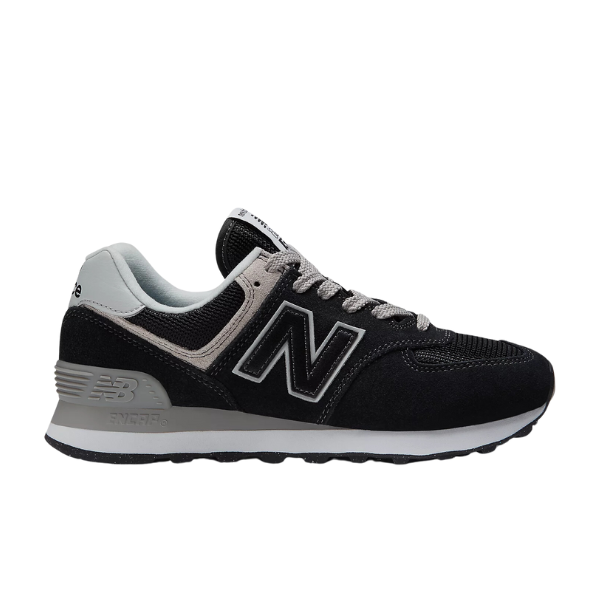The New Balance Womens 574 Core Black/White sneaker features black and grey tones, white accents, a signature N logo, white laces, and a grey cushioned sole—ideal for versatile everyday wear.
