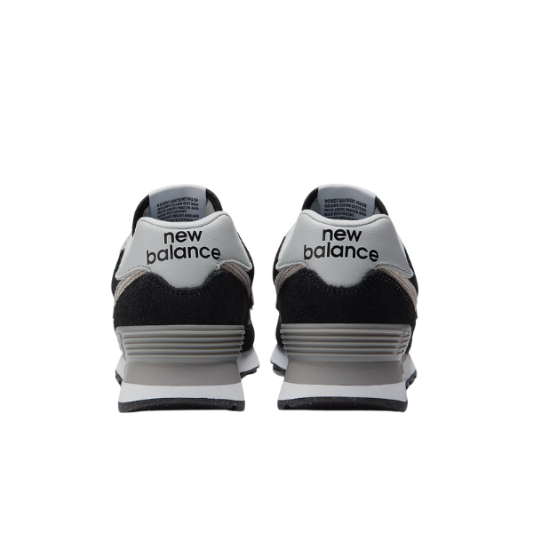 Back view of New Balance Womens 574 Core Black/White sneakers with new balance on the heels, shown against a plain white background.