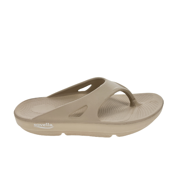 The Sovella Womens PF Thong Beige is a slip-on comfort sandal with thick sole, arch support, rebound technology, textured footbed, open toe design, and signature SOVELLA logo on the side.