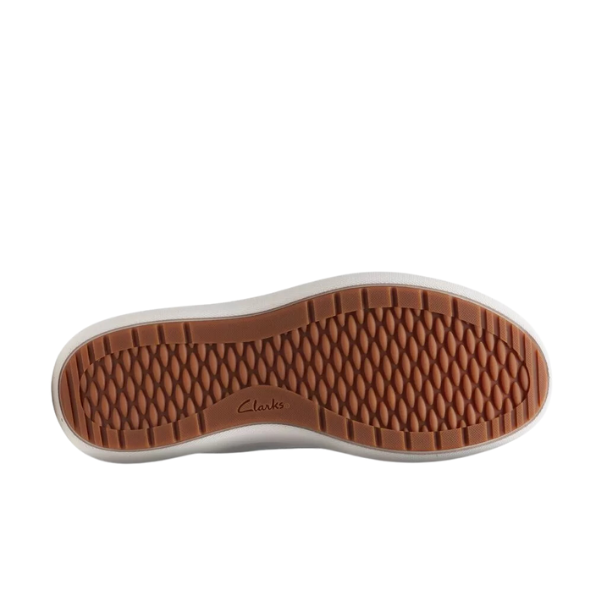 The image shows the bottom of the Clarks Womens Nalle Lace White sneaker with a brown, honeycomb-textured sole and CLARKS at the center. This zip-up shoe also features a Contour Cushion footbed for added comfort and pain relief.