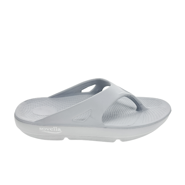 The Sovella Womens PF Thong Light Grey sandal by SOVELLA features a textured footbed and thick ergonomic sole with arch support, shown in side view on a white background.