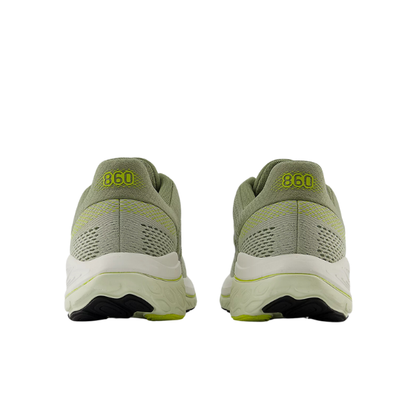 The New Balance Mens Fresh Foam 860v14 Green features light green and white colors, yellow 860 details on each heel, and delivers ultimate comfort with cushioned Fresh Foam.