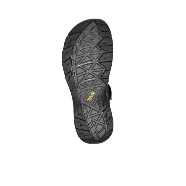 The Teva Mens Omnium 2 Hybrid Black sandal features a black sole with geometric tread, a yellow Teva logo at the center, and is designed for quick-drying performance—ideal for outdoor adventure. Shown from the bottom against a white background.