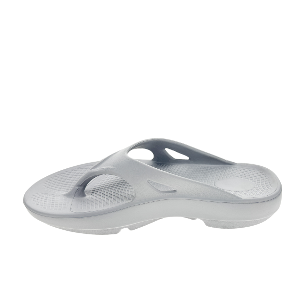 A Sovella Womens PF Thong Light Grey sandal by SOVELLA is shown in profile on a white background, featuring arch support, a contoured footbed, and textured sole.