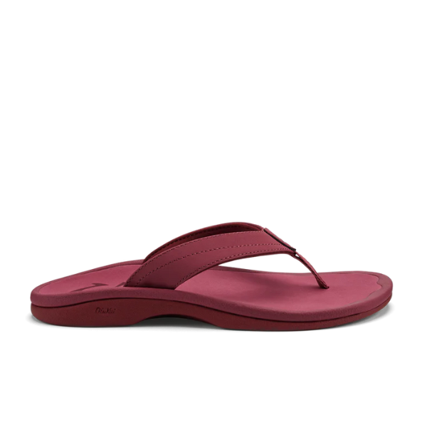 A side-profile of the OLUKAI Womens Ohana sandal in Red Earth/Bordeaux, featuring an anatomical footbed and a thick, curved strap, is displayed on a plain white background.
