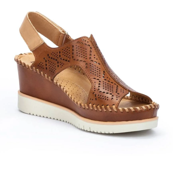 The Pikolinos Womens Aguadulce Brandy sandal by PIKOLINOS features cut-out geometric designs, a tan slingback strap, white sole, and visible stitching with a medium wedge heel and supportive insole for stylish comfort.
