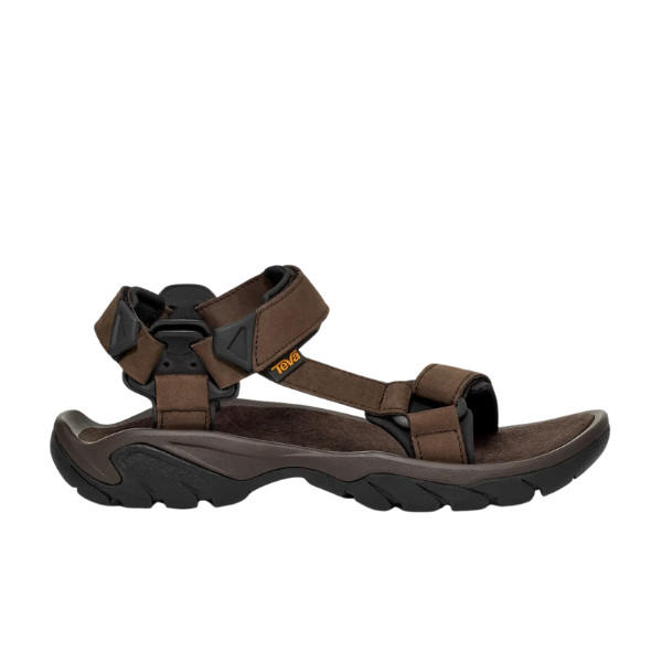 The Teva Mens Terra Fi 5 Universal Leather Turkish Coffee sandal features adjustable straps, a cushioned footbed, and a sturdy black sole for hiking. The brown leather design sports the Teva logo on the side strap.