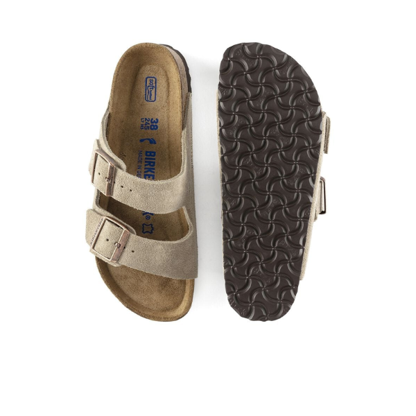 The BIRKENSTOCK Arizona Soft Footbed Taupe Suede sandals feature adjustable two-strap buckles, a cushioned footbed for foot pain support, and a dark textured sole, shown from top and bottom views.