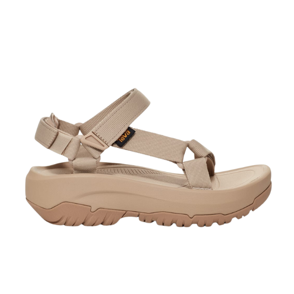 The Teva Womens Hurricane XLT2 Ampsole Sesame is a beige sport sandal with adjustable recycled fabric straps and a thick textured sole, ideal for outdoor or casual wear.