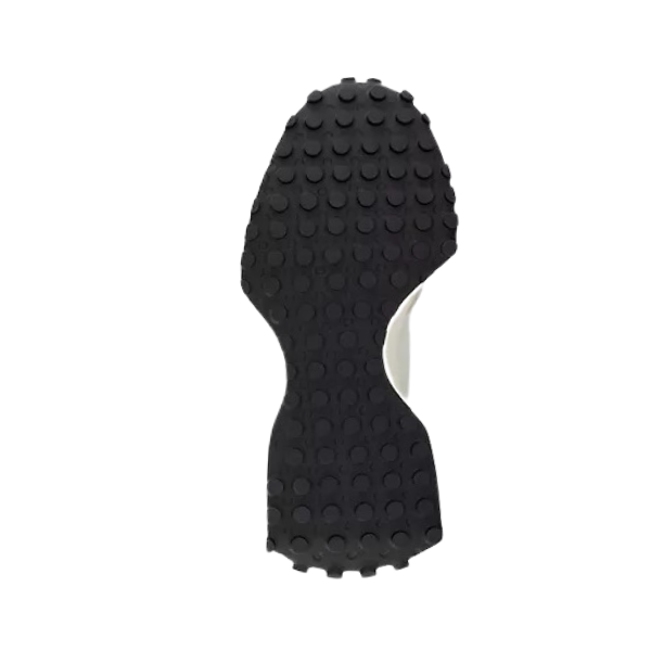 The black rubber sole of the NEW BALANCE Womens 327 White/Black sneaker features a textured surface with circular grip patterns, shown from the bottom and isolated on a white background.